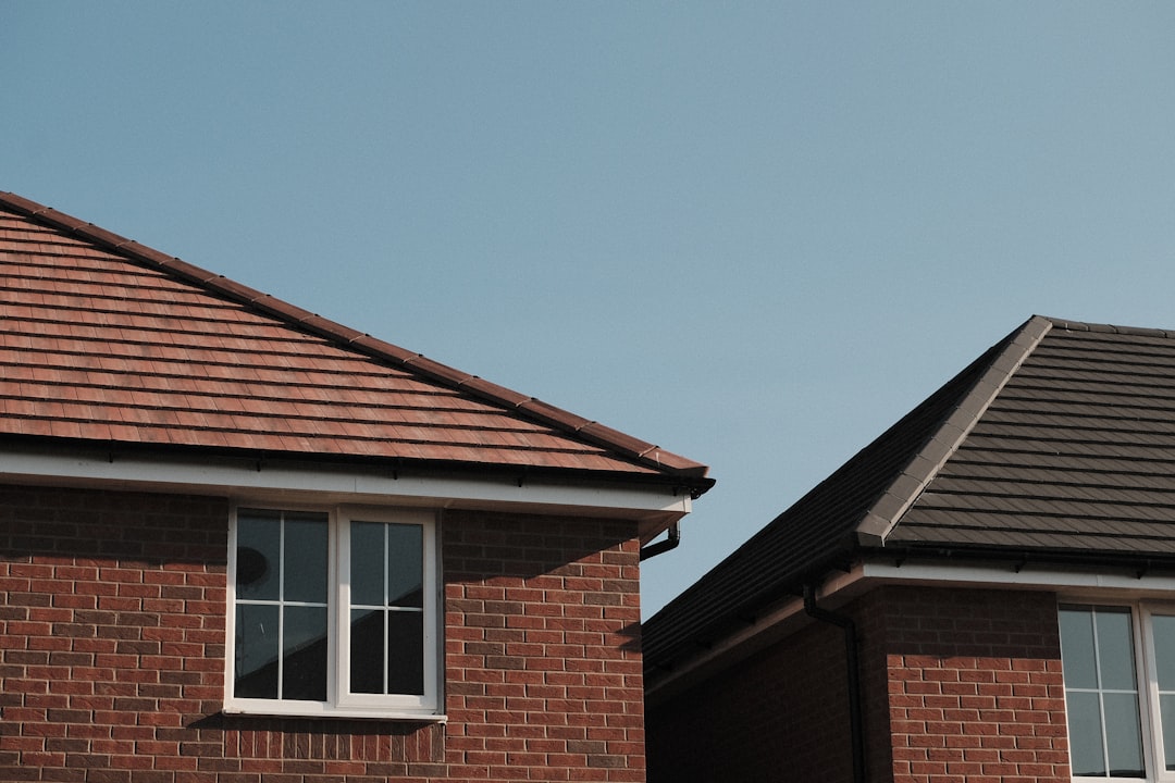 Residential Brick Houses brown brick house under blue sky during daytime
