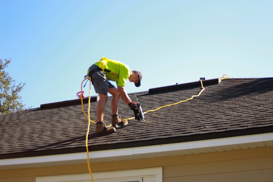 Roof Installation Work a man working on a roof with a power drill