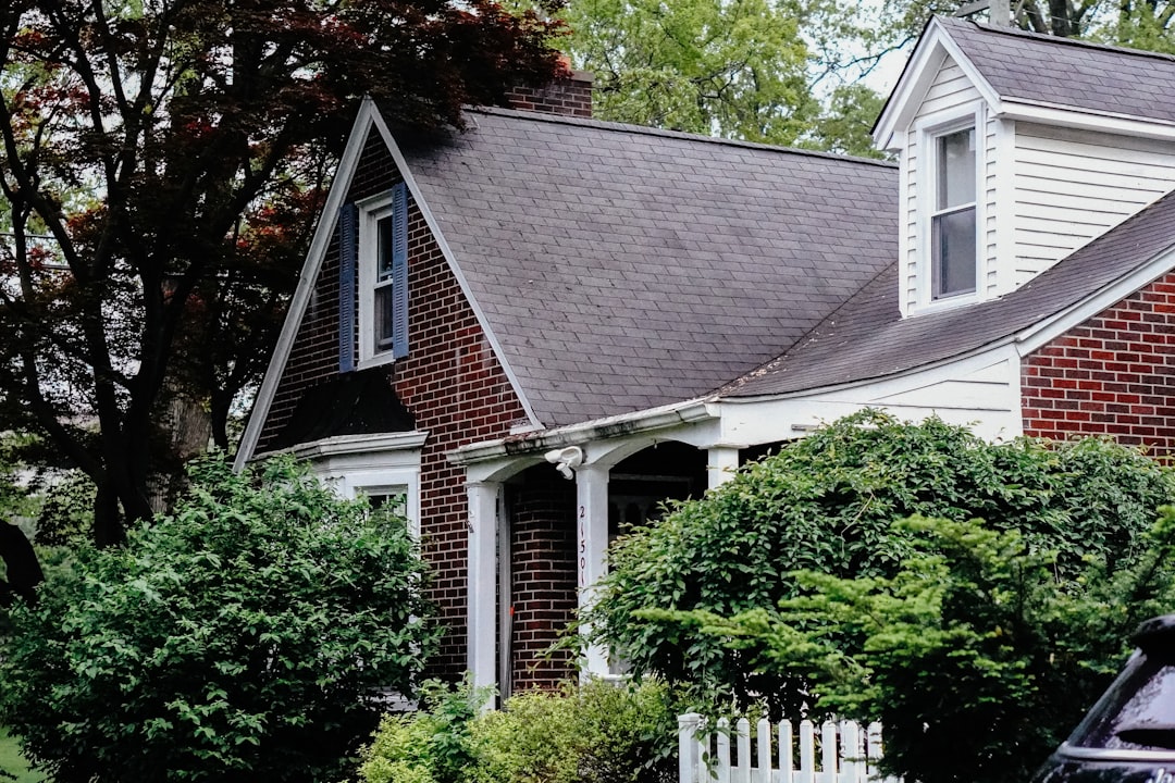Residential Property with Shingle Roof House with dormer and shrubbery.