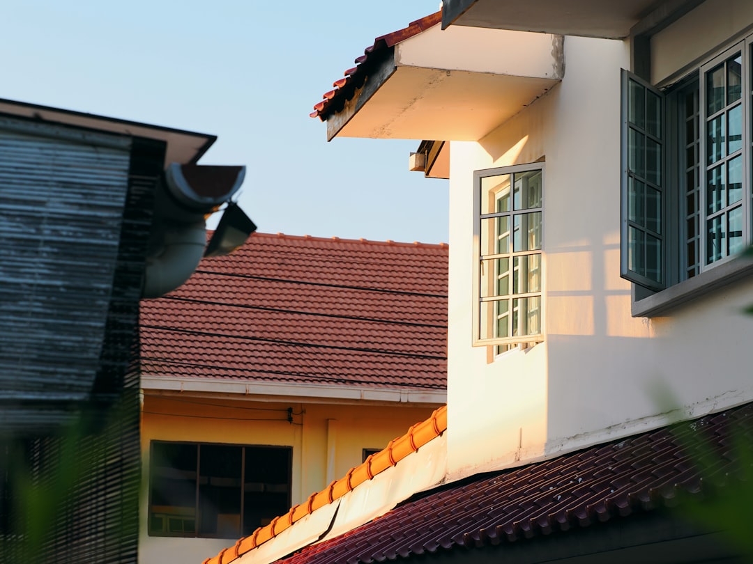 Several houses with tiled roofs under sunlight.