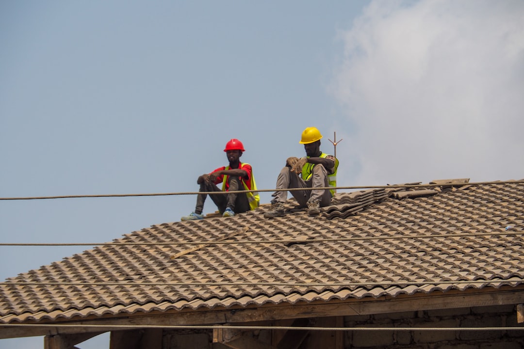 Roof Inspection by Kincaide Roofing Two construction workers are taking a break.