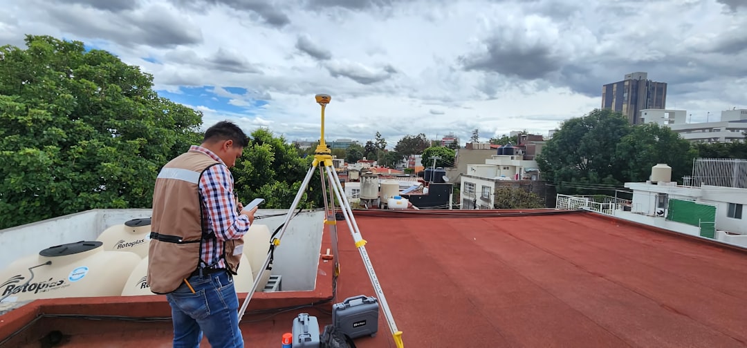 Roof Inspection Technician A man standing on top of a roof