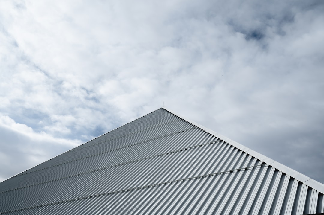 white building under white clouds during daytime