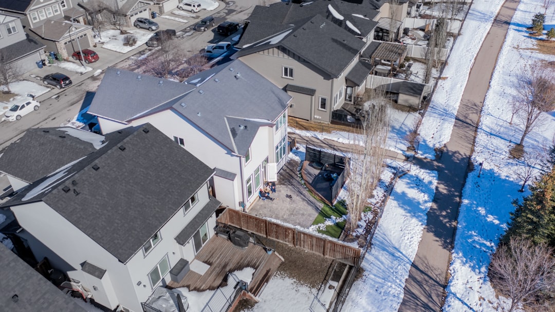 Aerial view of suburban houses and streets covered in snow.