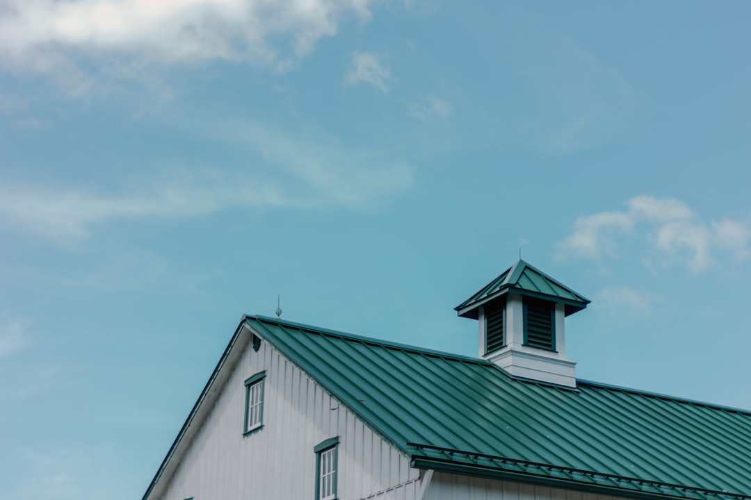 White Building with Green Roof a white building with a green roof and a steeple