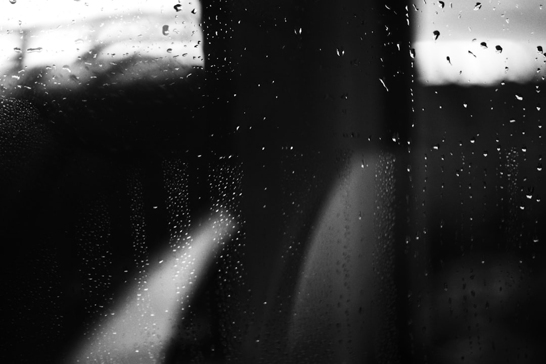 Raindrops on a window with blurred background