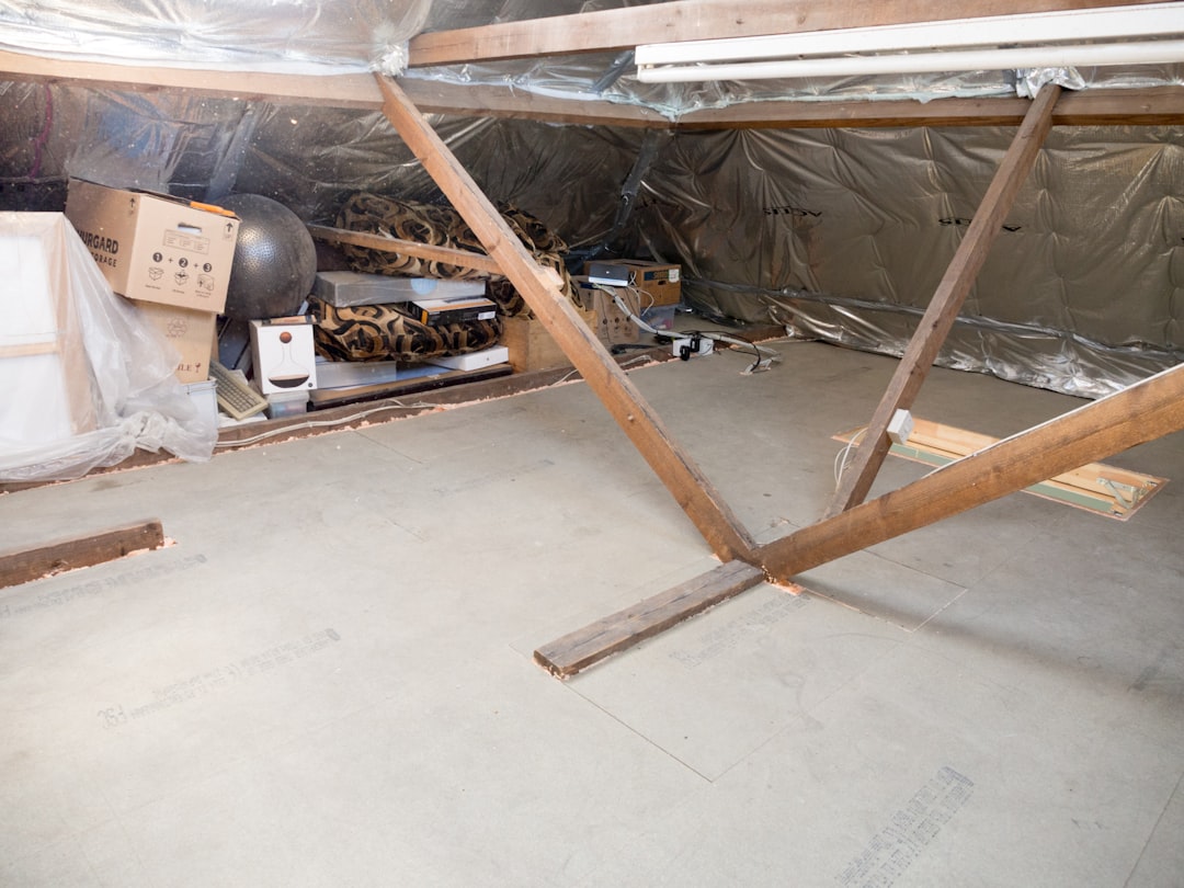 An unfinished attic space with wooden support beams.