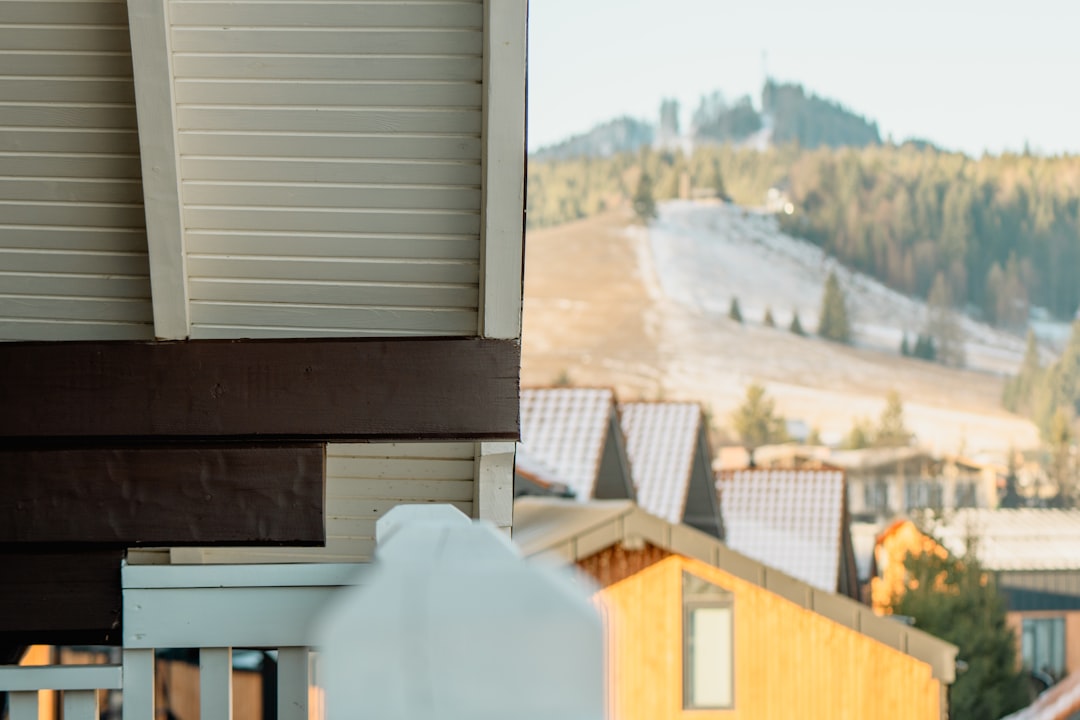 Close-Up of Building Corner Wooden houses with snowy mountain landscape background