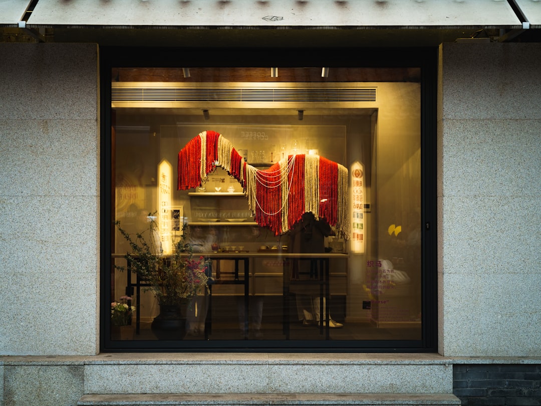 Storefront Window Display A storefront window displaying red and white fabric with pearls.