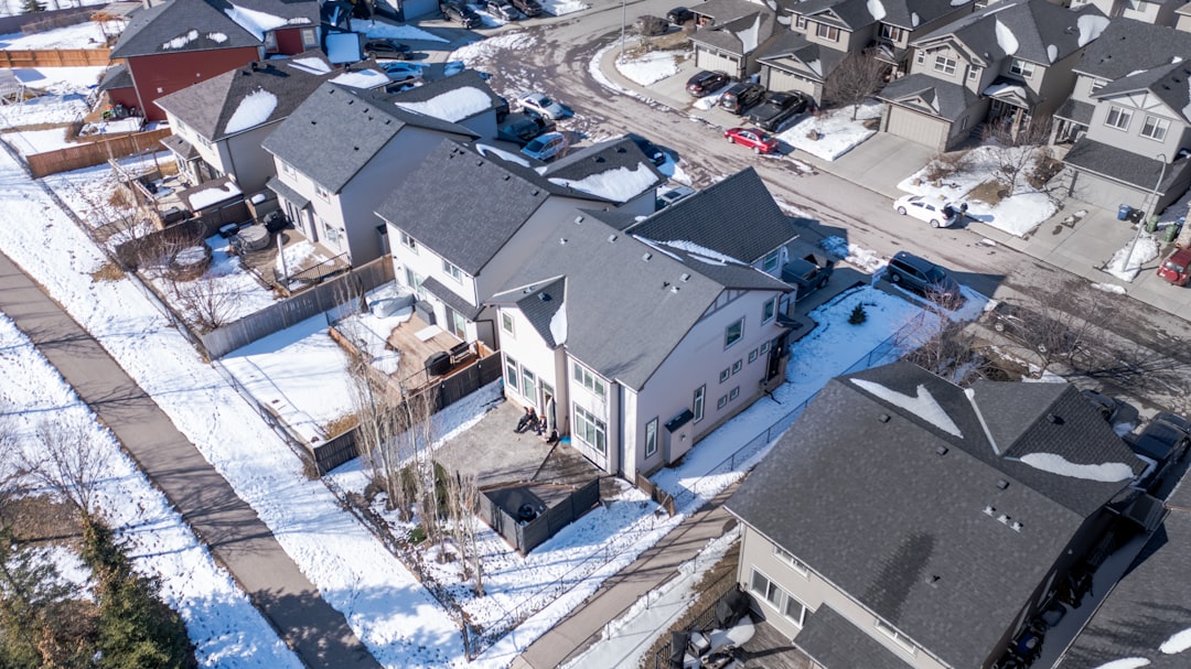 Aerial view of a residential neighborhood covered in snow.