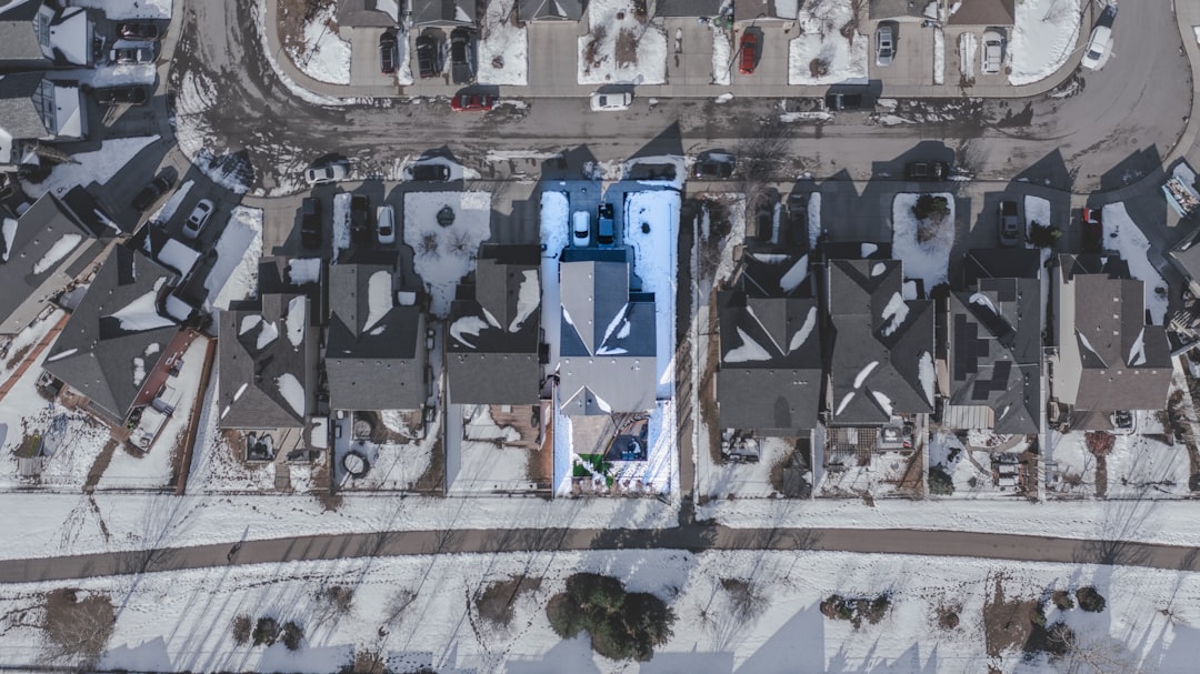 Winter Neighborhood Aerial View Aerial view of snow-covered residential neighborhood with one house highlighted.