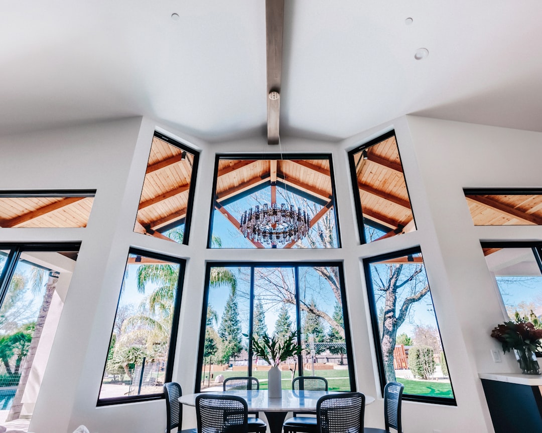 Modern dining room with large windows and chandelier