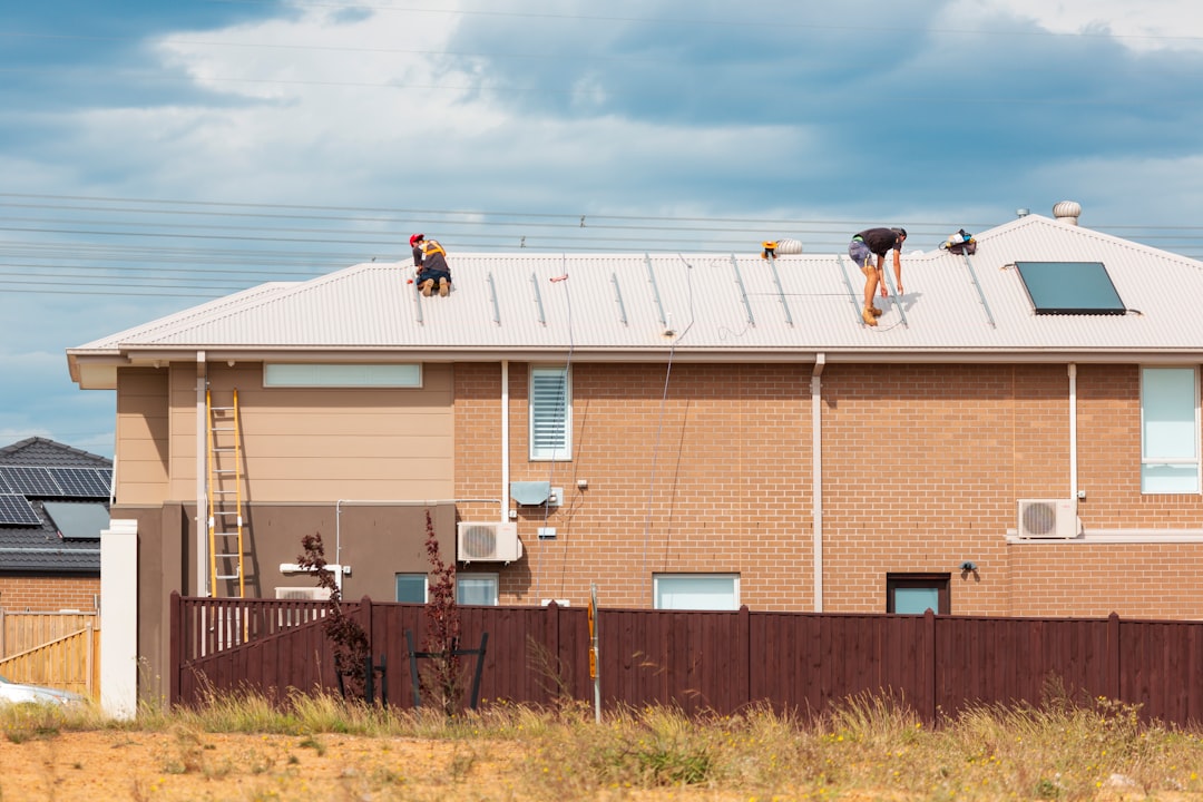 Roof Installation at Residential Property brown and white concrete building under blue sky during daytime