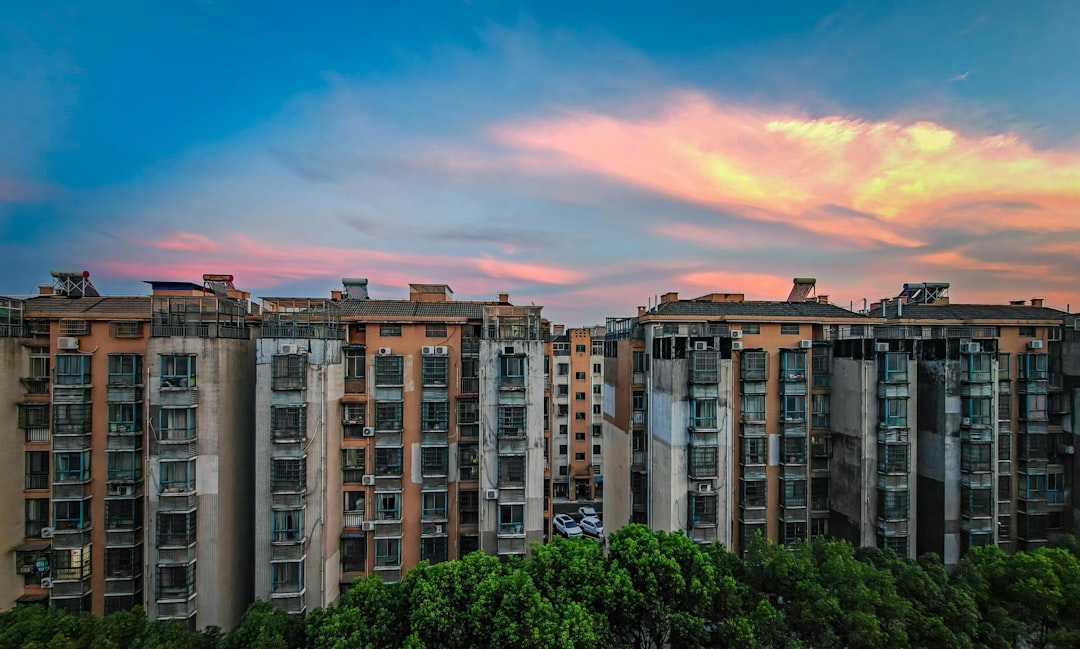 Apartment buildings under a colorful sunset sky