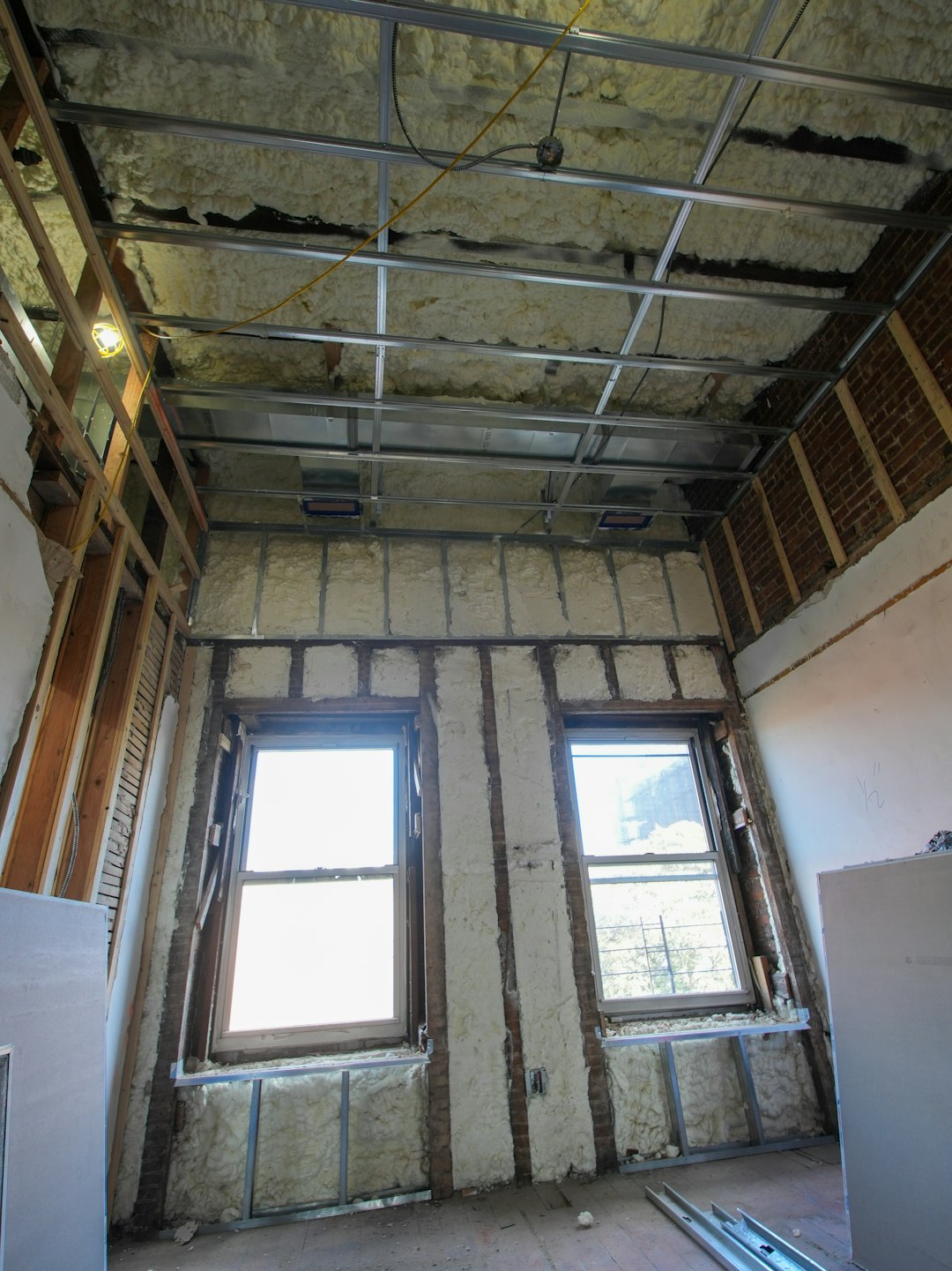 Interior room under construction with exposed framing and insulation.