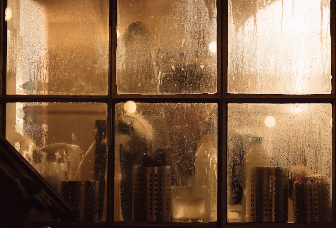 Bottles and containers seen through a steamy window.