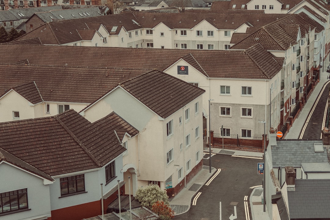Rows of modern houses with brown roofs and white walls.