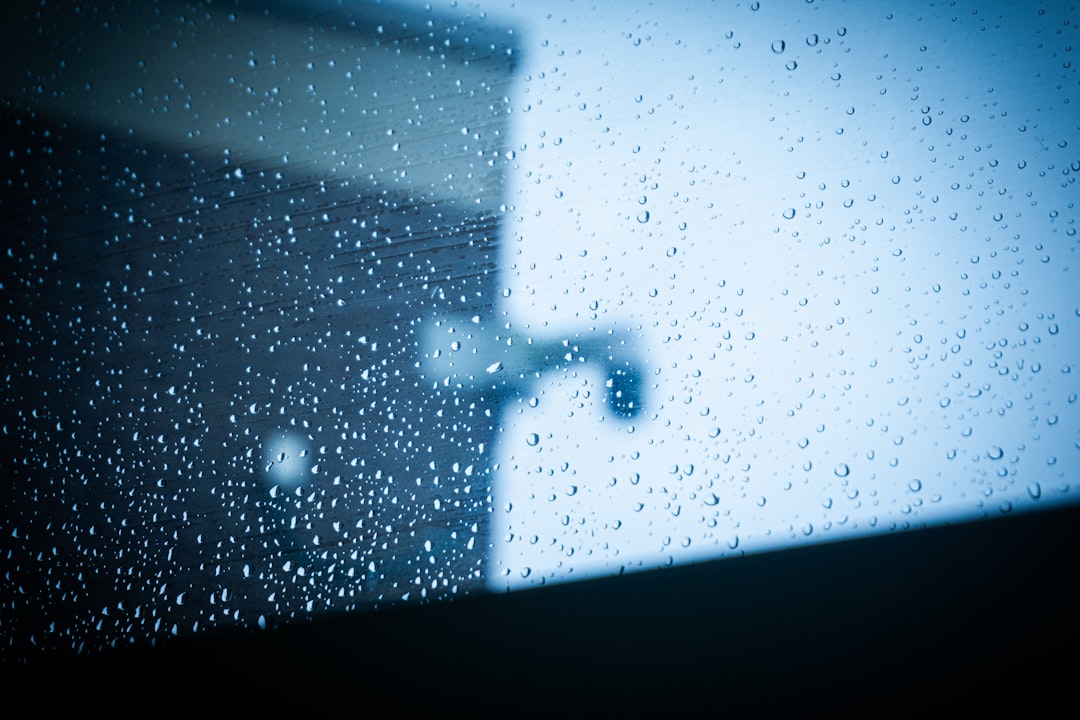 Raindrops on Window Raindrops on a window with blurred building reflection