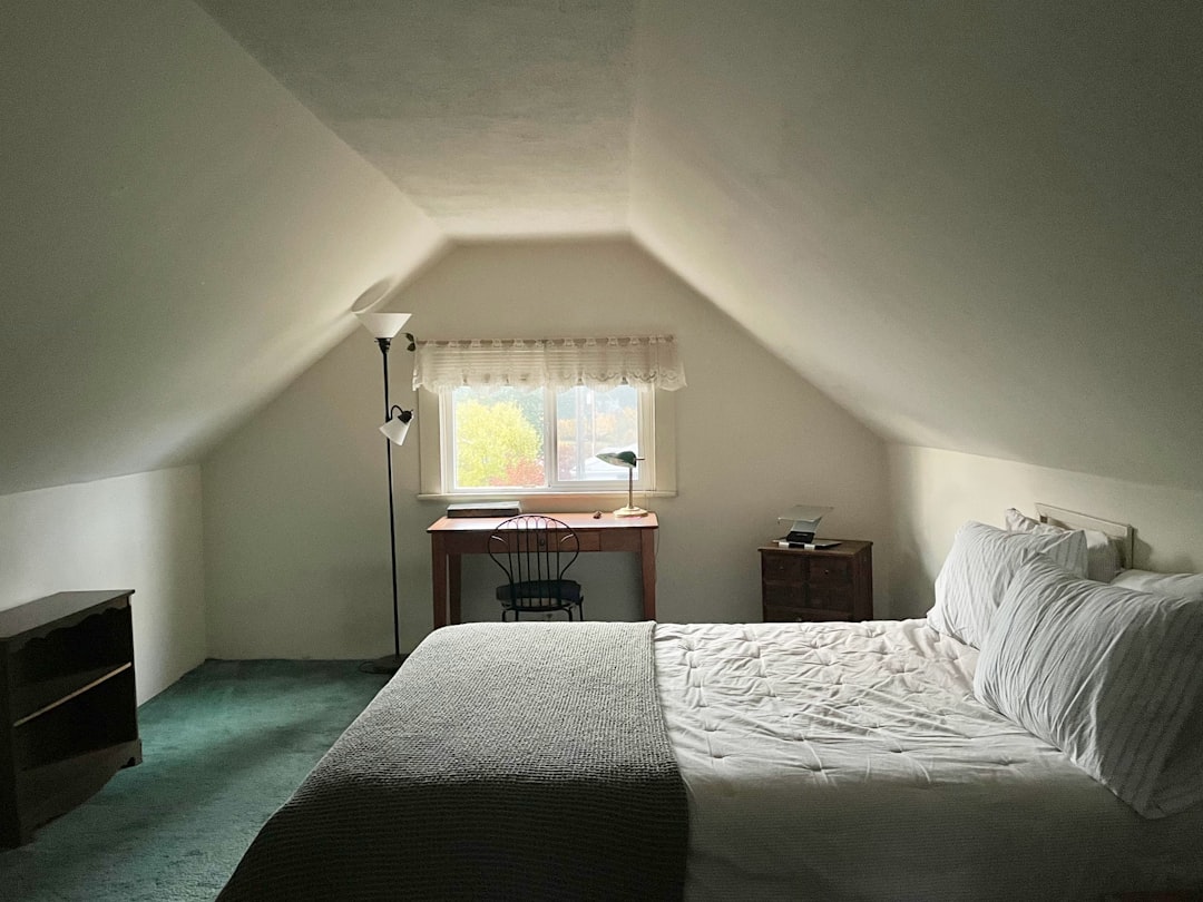 Attic bedroom with a bed and window