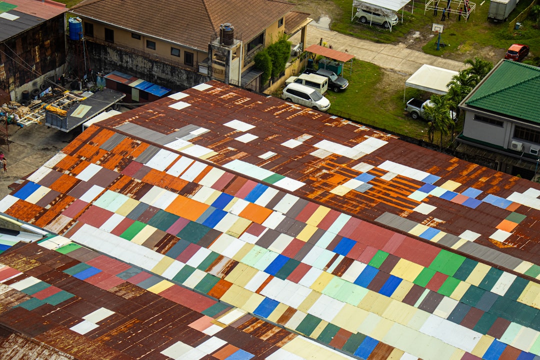 Building roof covered in many colorful, rectangular patches.