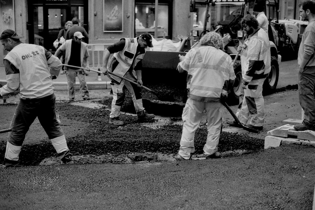 Road Patching Crew a black and white photo of a group of people