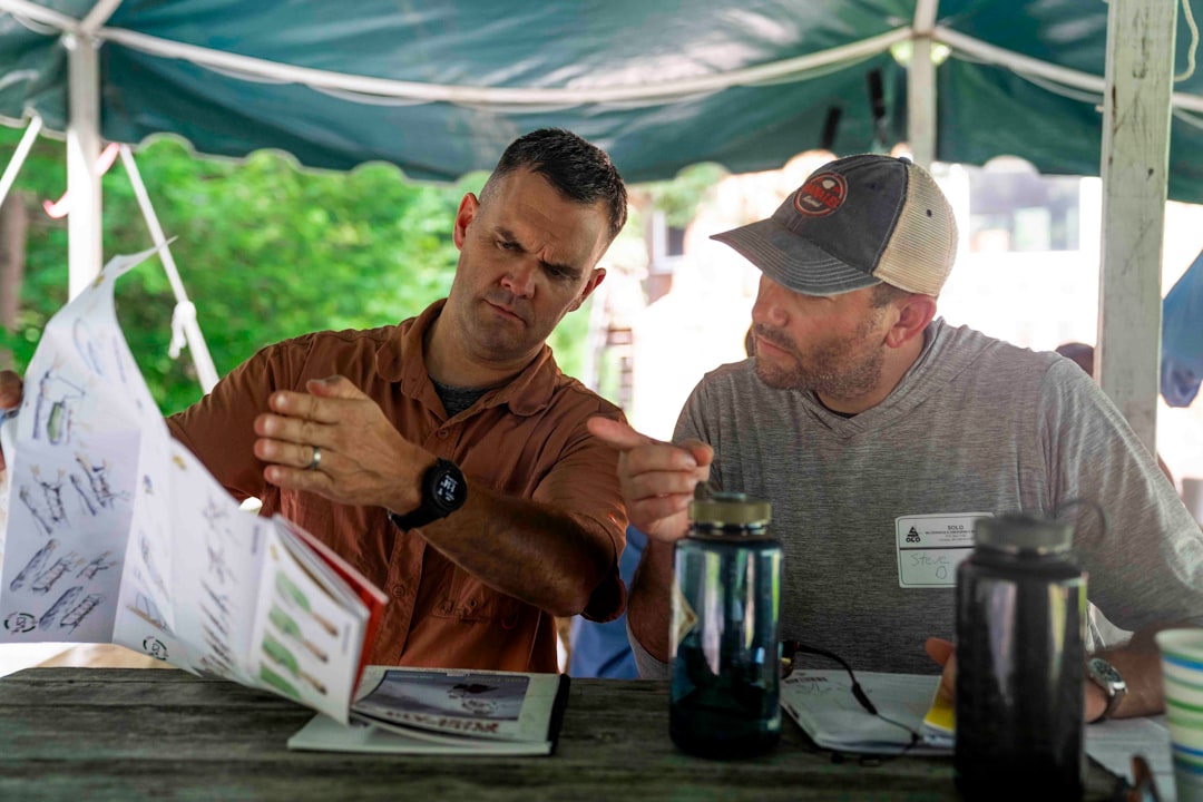 Men Reviewing Roofing Brochure Two men looking at a document together at a table