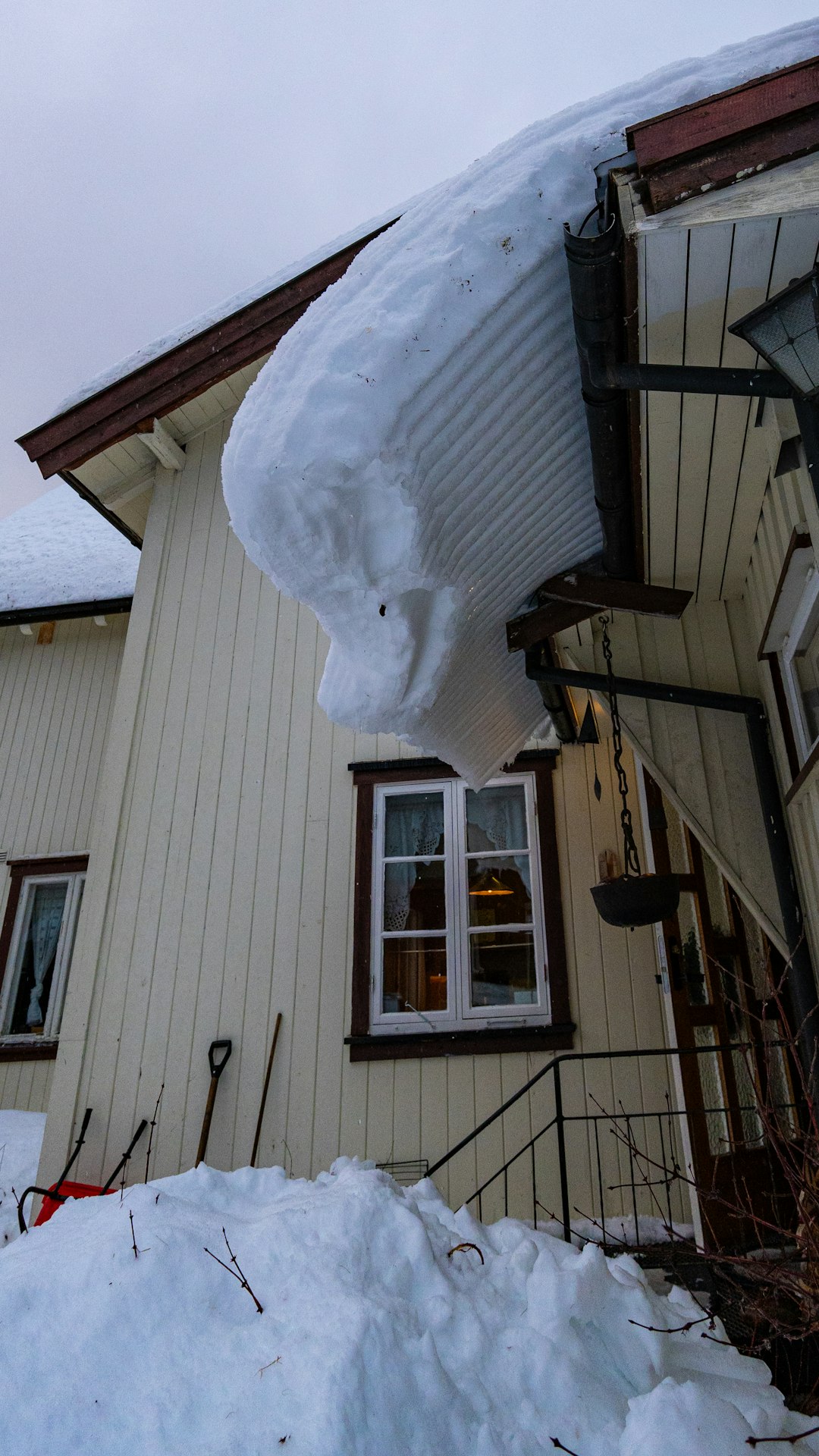 A house with snow on the roof and windows