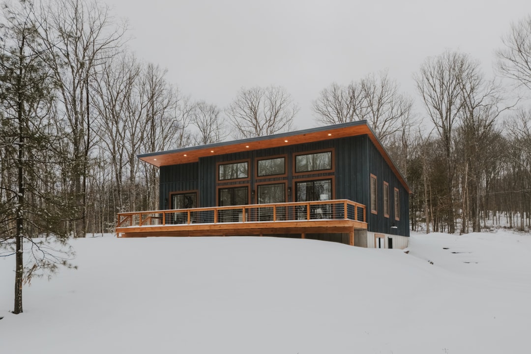 Modern house with wooden deck in snowy landscape