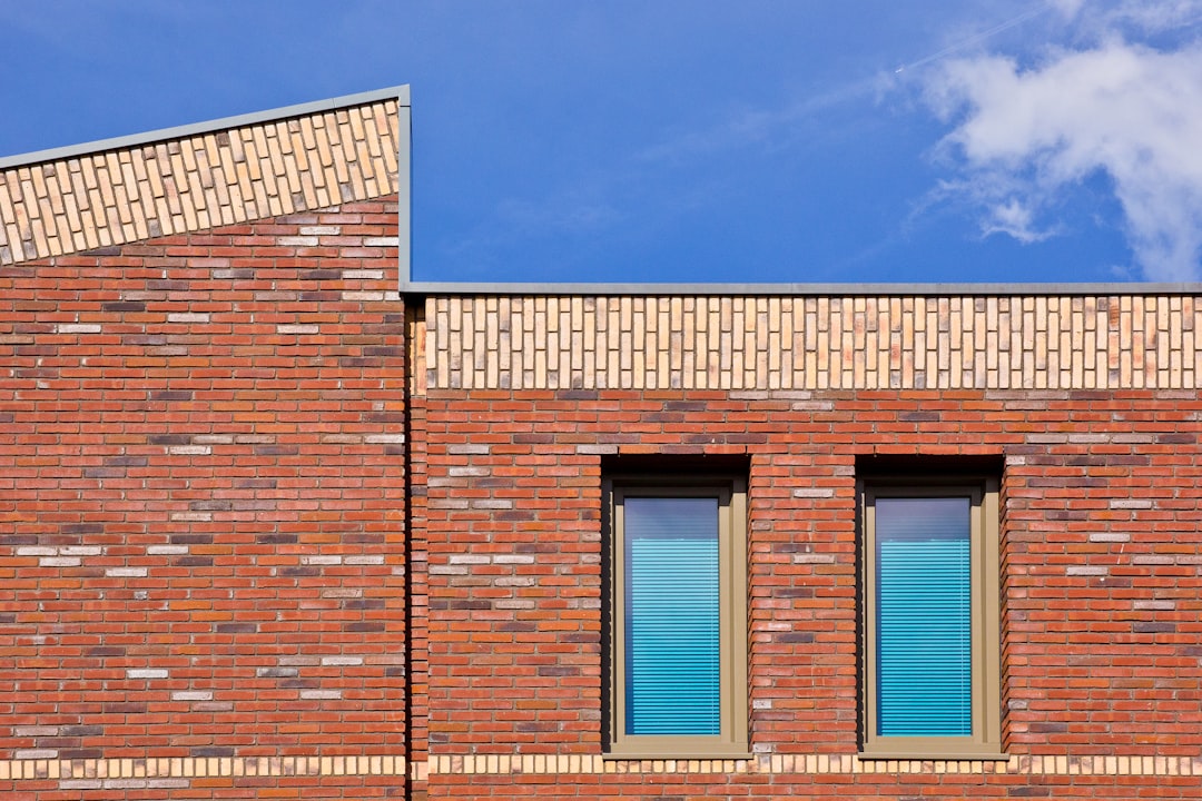 Modern brick building facade with two windows.