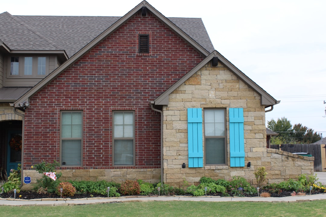 a red brick house with blue shutters
