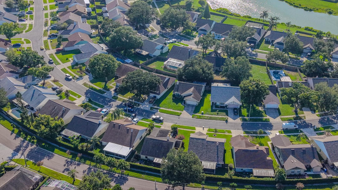 38f64d1e8f294bb3ab53446a4e18eb7c Residential neighborhood with houses, winding streets, and green trees