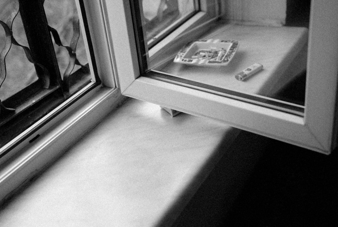 3b53dbdbe4fa4116bb3132af563c9414 a broken cell phone sitting on a window sill