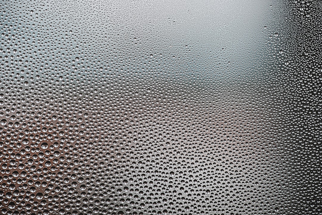 A close up of a window with water droplets on it