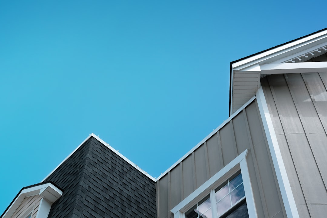 Houses with Roofs Against Blue Sky a building with a blue sky in the background