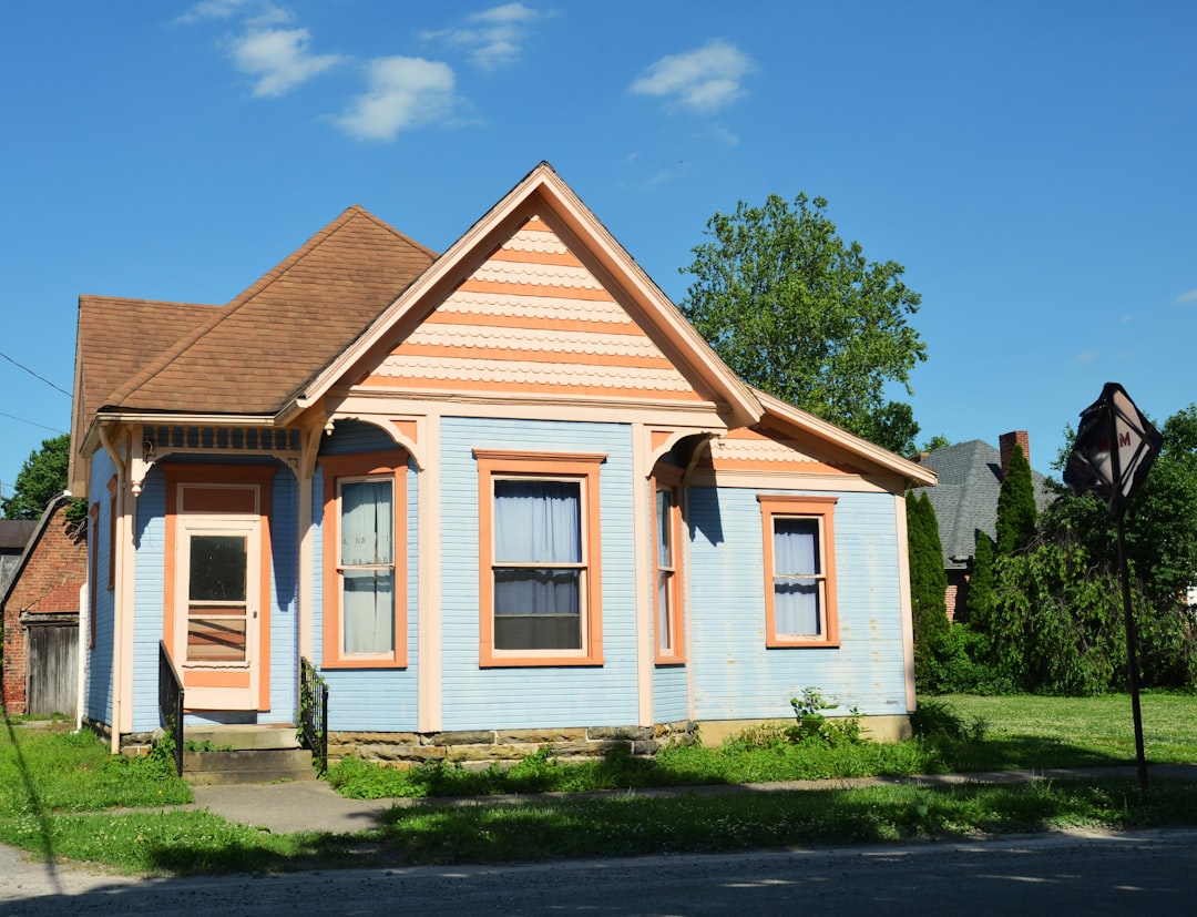 A charming light blue house with peach trim.