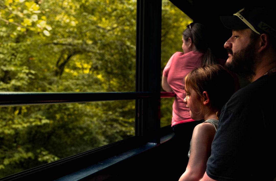 Family looking out window at green trees