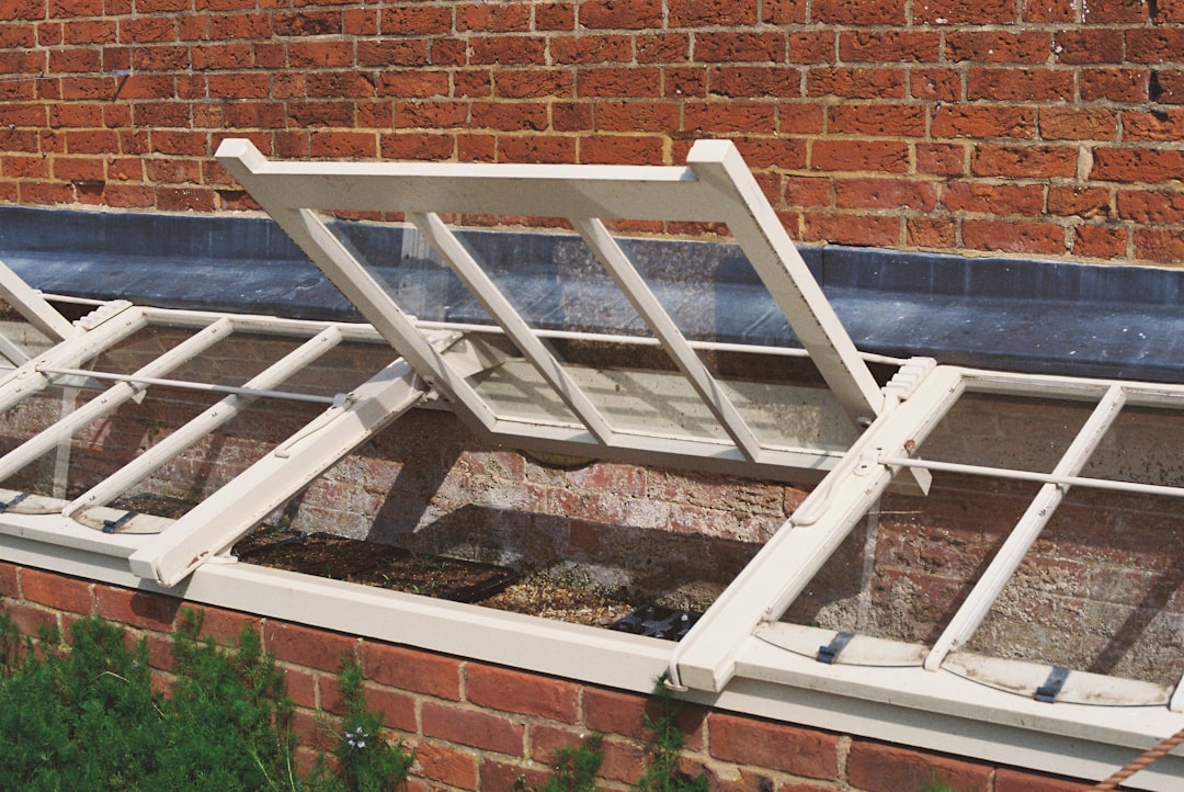 51803f993f1b4b93a55f2b23aa1f9f6e Open casement windows on a brick building