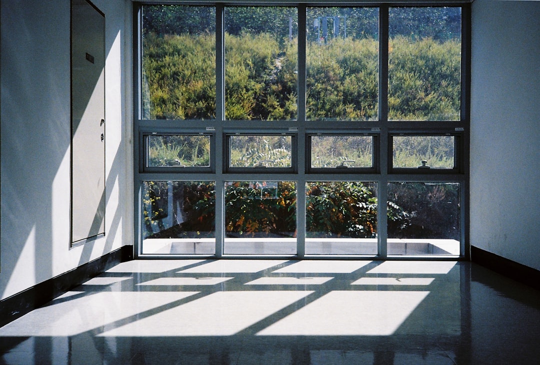 A room with a large window and a view of a field
