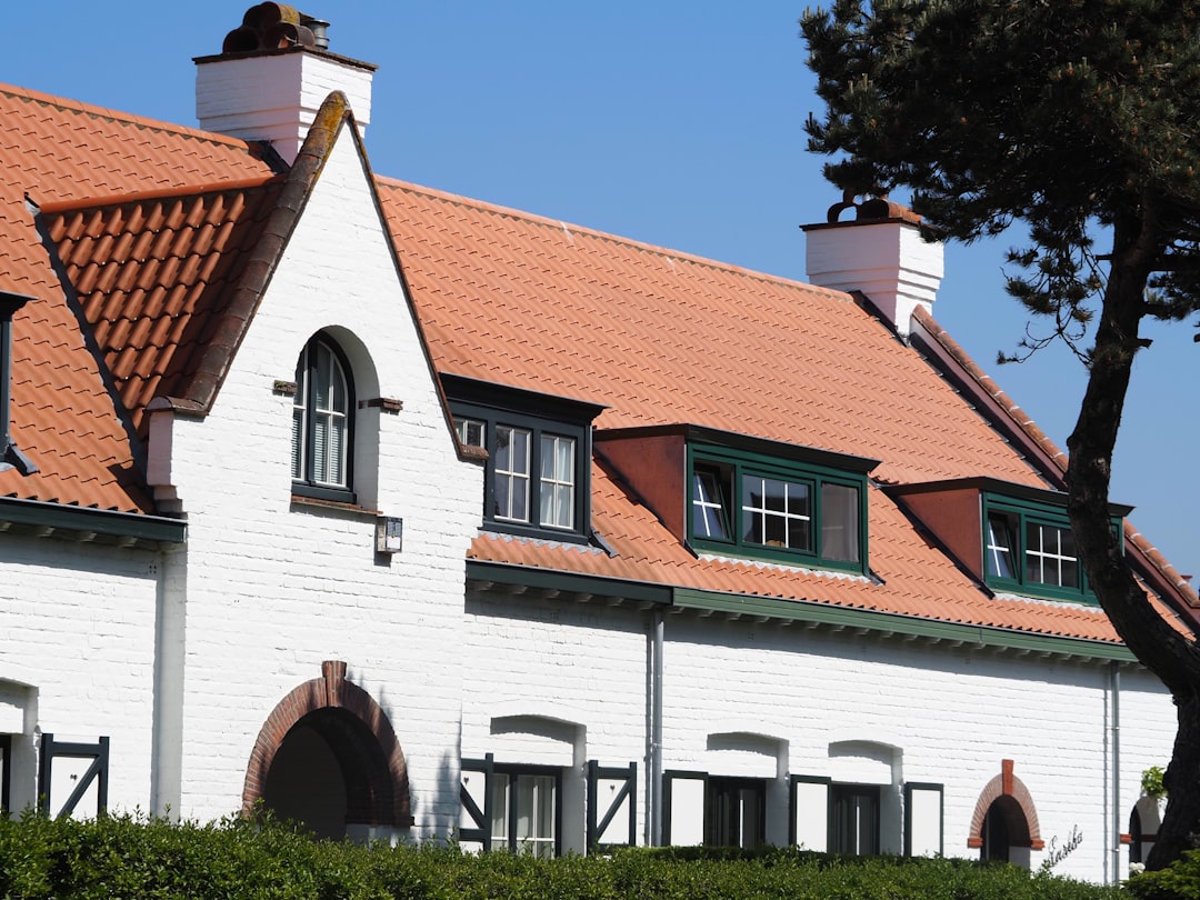 a white house with a red tiled roof