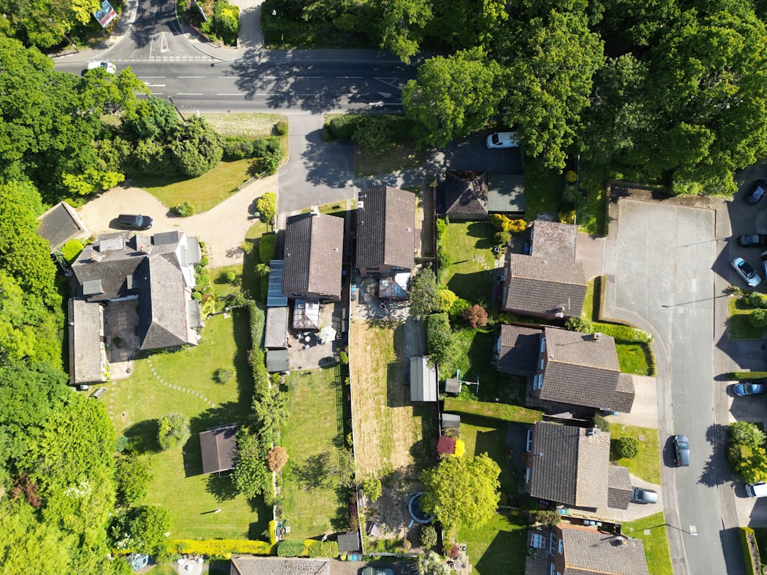 5a72597eab7547c9b36001dc473e3b05 Aerial view of houses, gardens, roads, and green trees