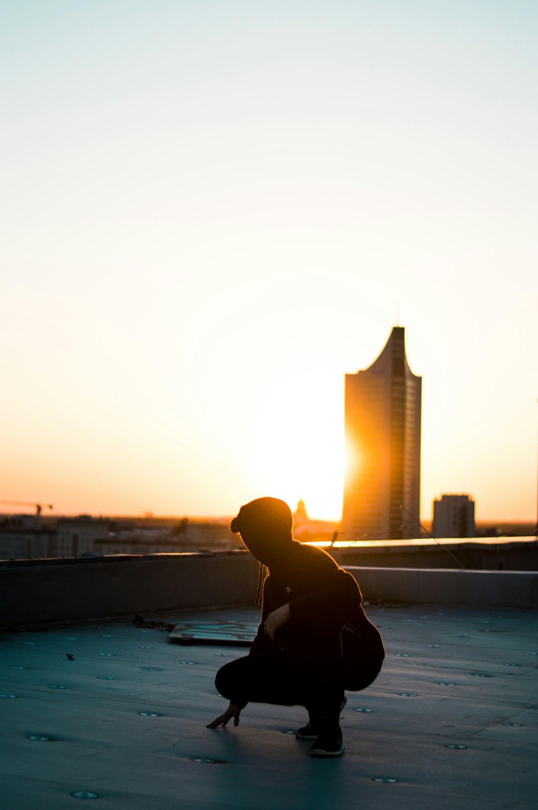 5e33752cd13e4b3badc7b32d7c86b28b silhouette photography of woman squatting on rooftop