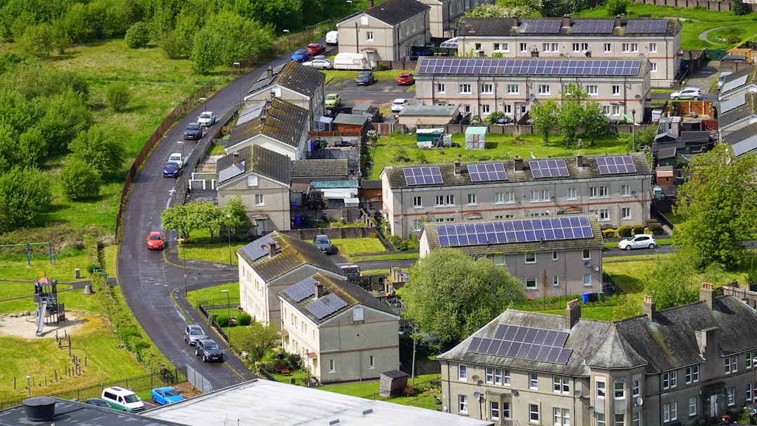 Aerial view of a residential neighborhood with solar panels on grey rooftops