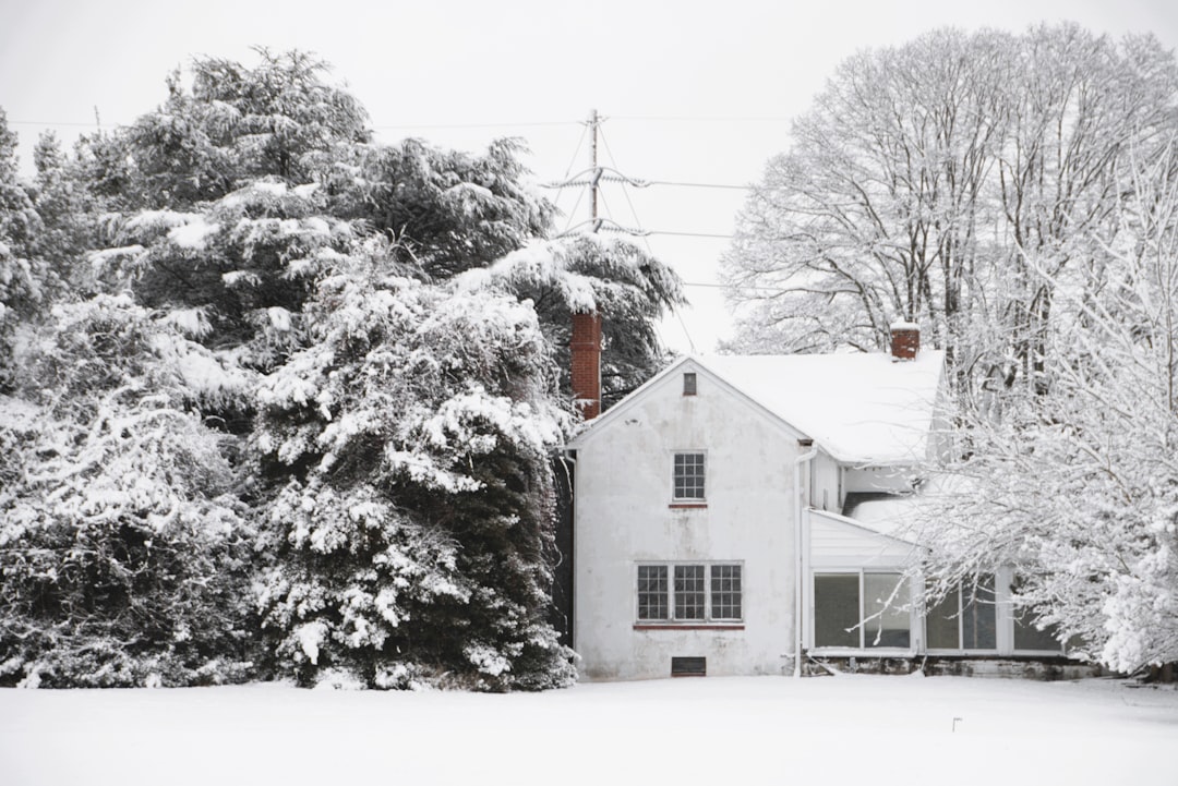 A white house covered in snow during winter.