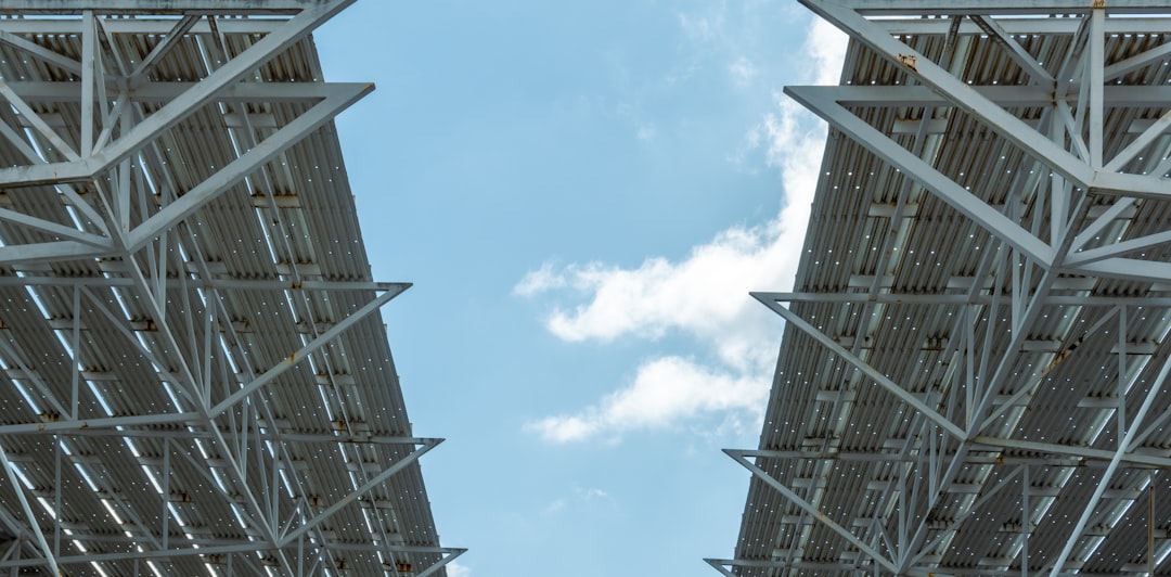 6b8faab4a49c406caa8134d32772d5d9 a couple of tall metal structures under a blue sky