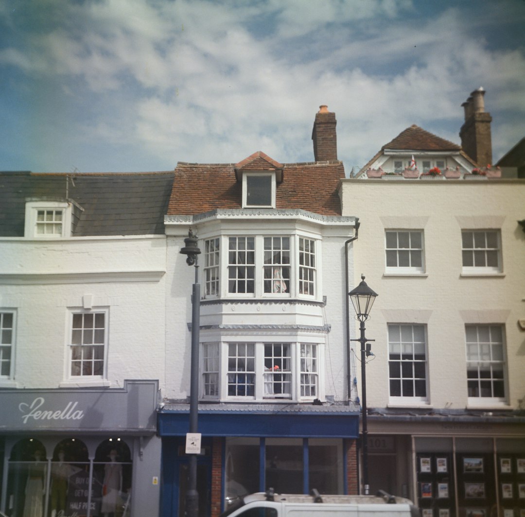 Row of white buildings with a prominent bay window
