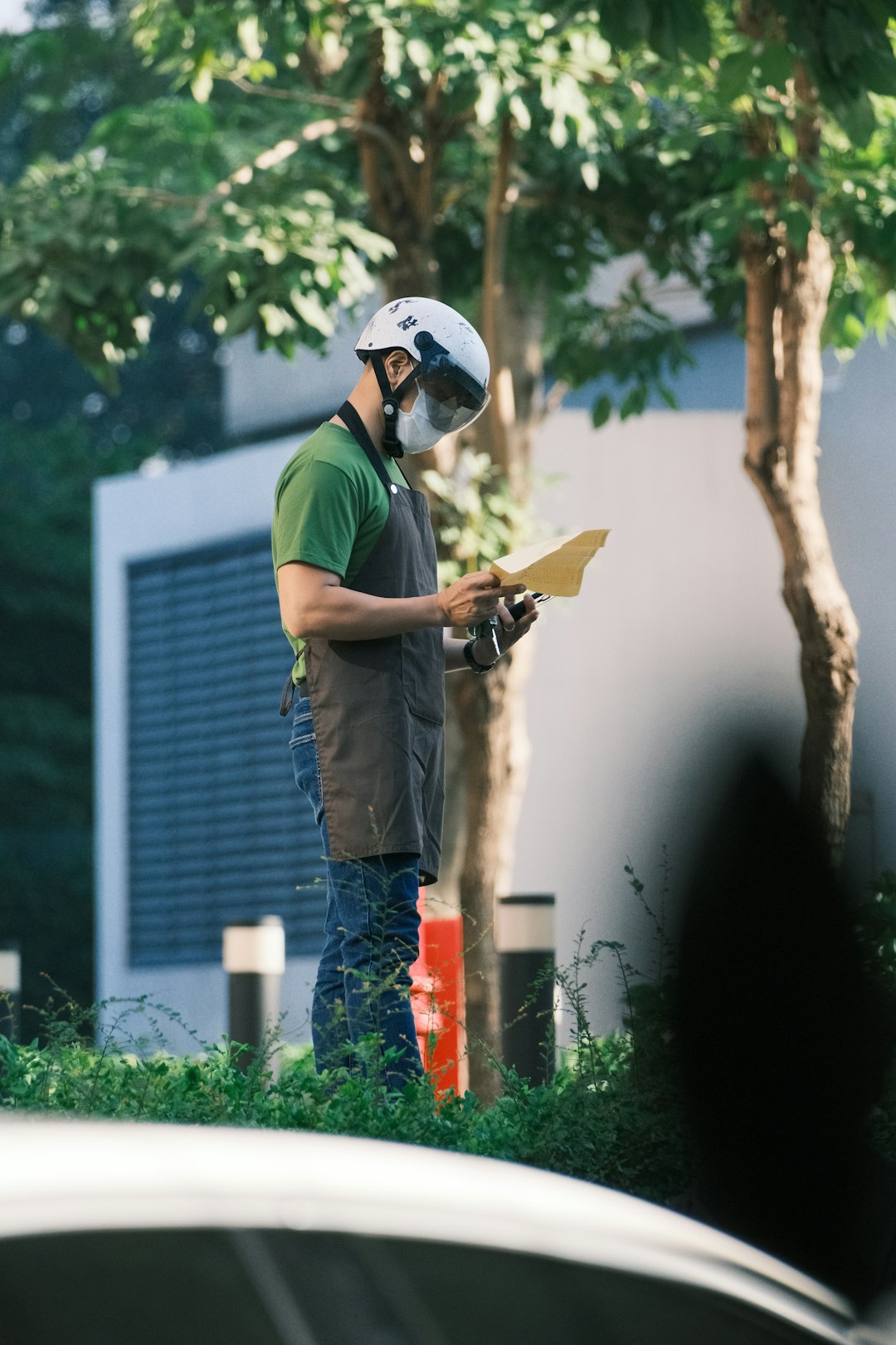 Roof Inspection Team Member a man wearing a helmet and holding a piece of paper