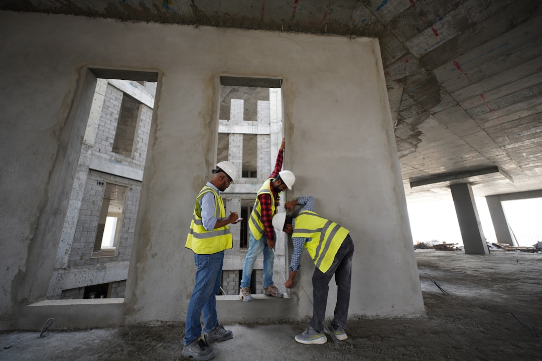 73893b753f554ff1adbe0dfa6a1a7bb8 a group of men standing next to each other in front of a building
