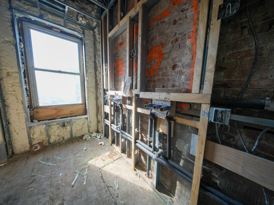 Interior Renovation Underway Interior room under construction with exposed pipes and wiring.