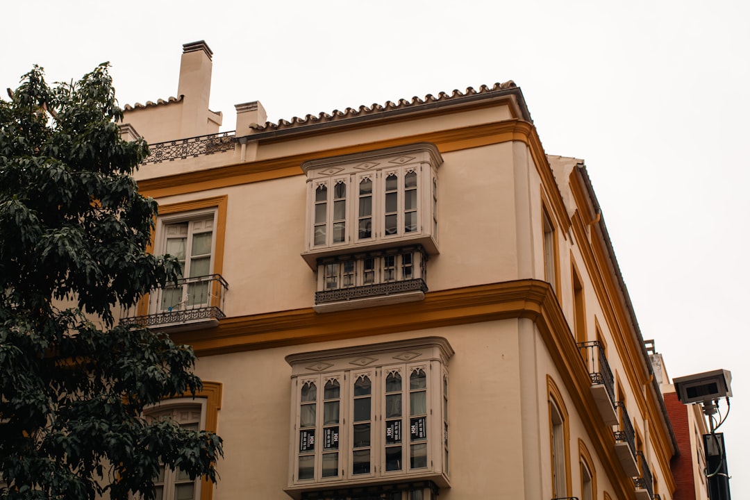 Corner of a building with ornate balconies and windows