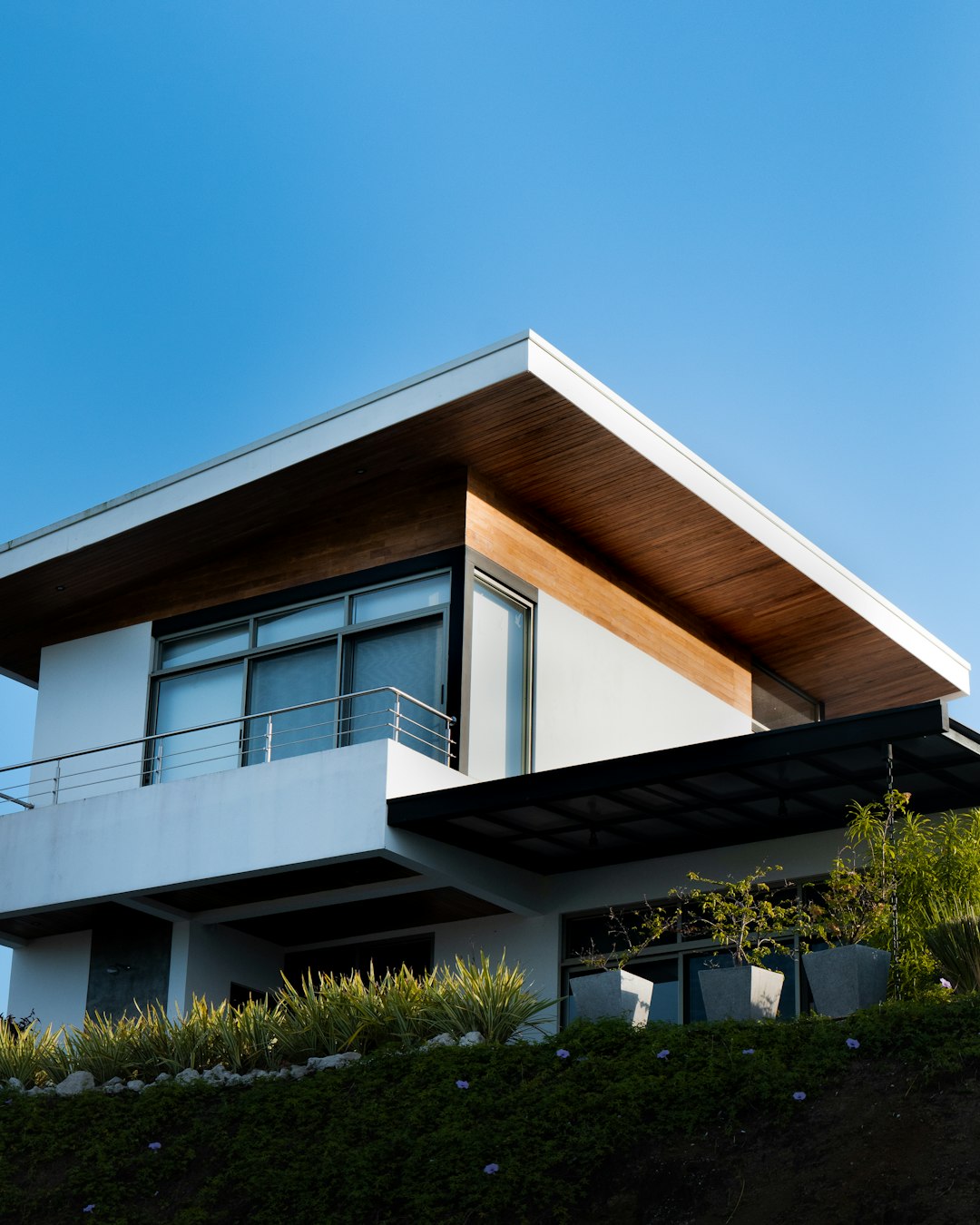 7b07a54c5c304cdf89ce6cd140577b26 a house with a balcony and a balcony railing